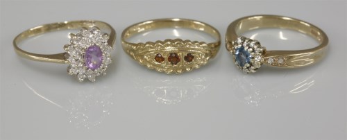 Lot 1034 - A 9ct gold amethyst and diamond oval cluster ring