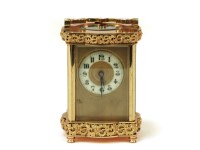 Lot 1108 - A French brass carriage clock
with fretted brass decoration
16.5cm high to top of handle