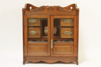 Lot 565 - An Edwardian oak smoker's cabinet