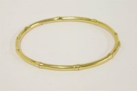 Lot 28 - An Edwardian hinged gold bamboo bangle