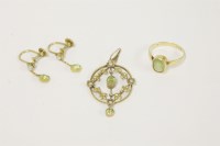 Lot 36 - A gold single stone rub set oval cut peridot ring