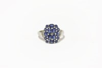 Lot 27 - A 9ct white gold sapphire and diamond cluster ring