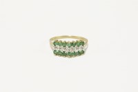 Lot 35 - A gold three row diamond and emerald ring