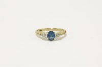 Lot 39 - A 9ct gold oval cut topaz and trefoil diamond set shoulder ring