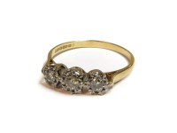 Lot 1019 - An 18ct gold three stone illusion set diamond ring