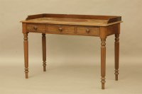 Lot 582 - An early 19th century three drawer writing table