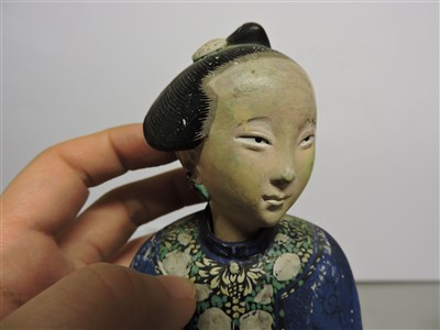 Lot 90 - A Chinese painted clay nodding-head figure