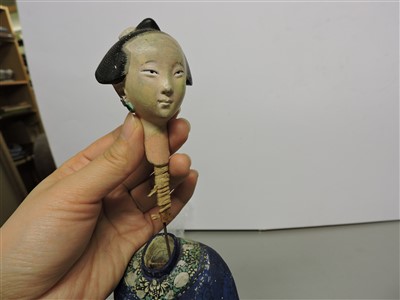 Lot 90 - A Chinese painted clay nodding-head figure