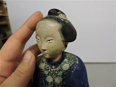 Lot 90 - A Chinese painted clay nodding-head figure