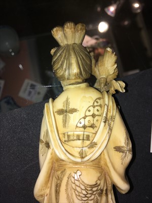 Lot 129 - Two Japanese carved ivory figures
