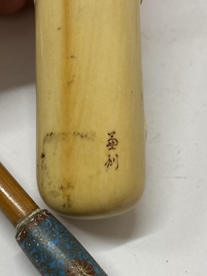 Lot 36 - A Japanese ivory kiseruzutsu with kiseru