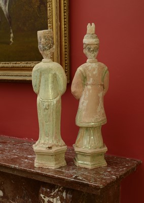 Lot 128 - A pair of Chinese Tang dynasty glazed terracotta burial figures (minggi)