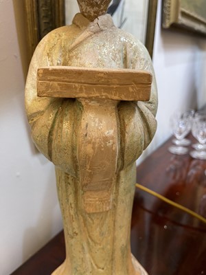 Lot 128 - A pair of Chinese Tang dynasty glazed terracotta burial figures (minggi)