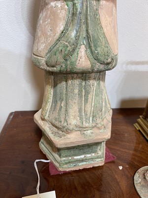 Lot 128 - A pair of Chinese Tang dynasty glazed terracotta burial figures (minggi)
