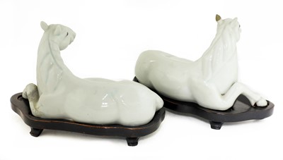 Lot 55 - A pair of Chinese white-glazed horses