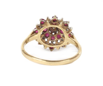 Lot 1221 - A 9ct gold diamond and ruby target cluster ring