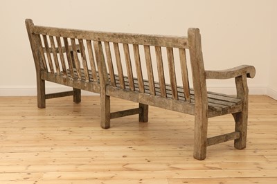 Lot 97 - A large weathered teak country house bench