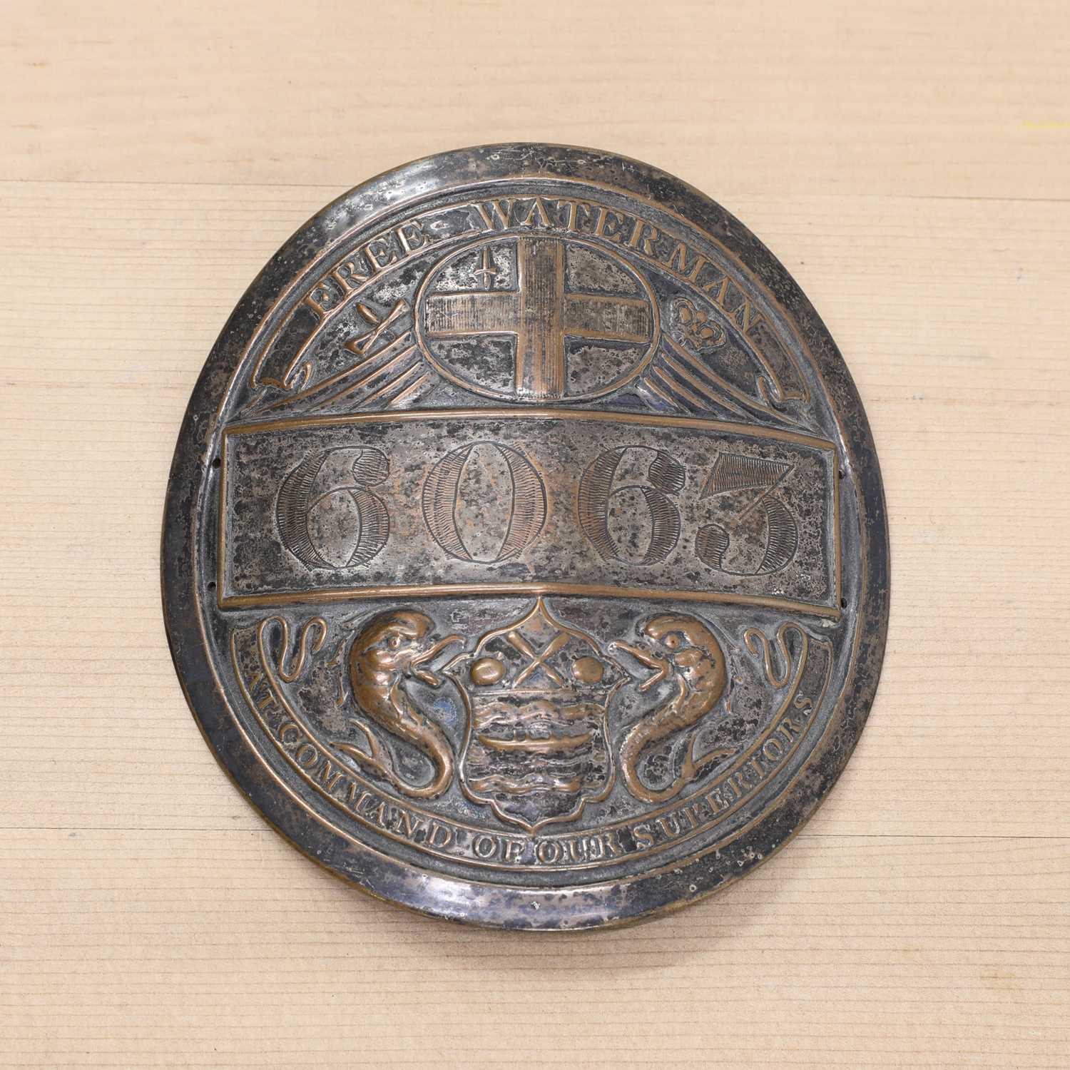 Lot 364 - A silver-plated copper Free Waterman badge