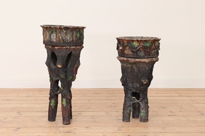 Lot 447 - Two similar rusticated pottery jardinieres on stands