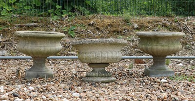 Lot 469 - A group of three composite stone garden urns