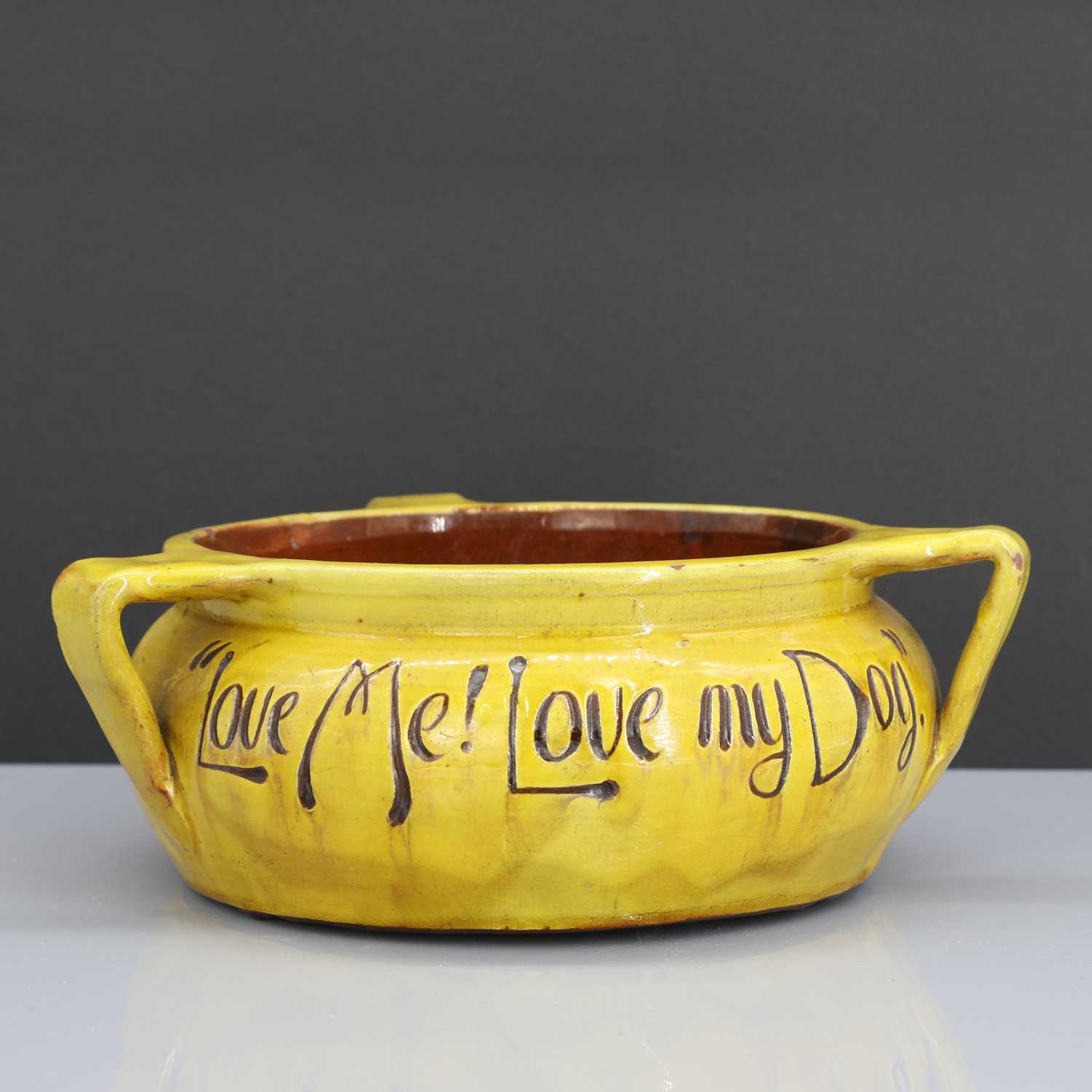 Lot 47 - A rare Liberty & Co. yellow pottery dog bowl