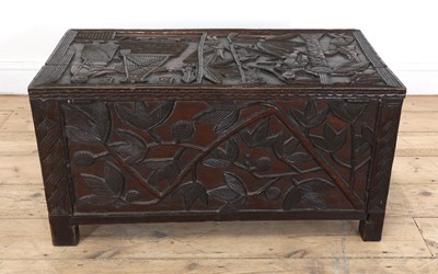 Lot 212 - A carved African coffer