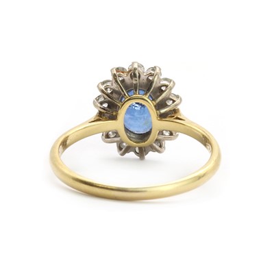 Lot 102 - An 18ct gold sapphire and diamond oval cluster ring