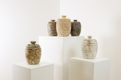 Lot 517 - Five carved alabaster jars and covers