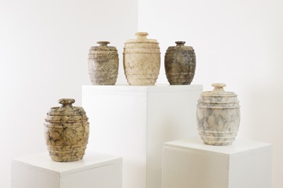 Lot 517 - Five carved alabaster jars and covers