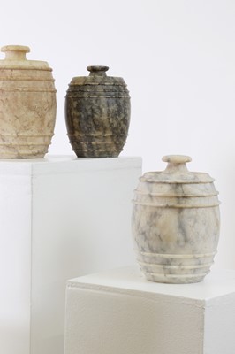 Lot 517 - Five carved alabaster jars and covers