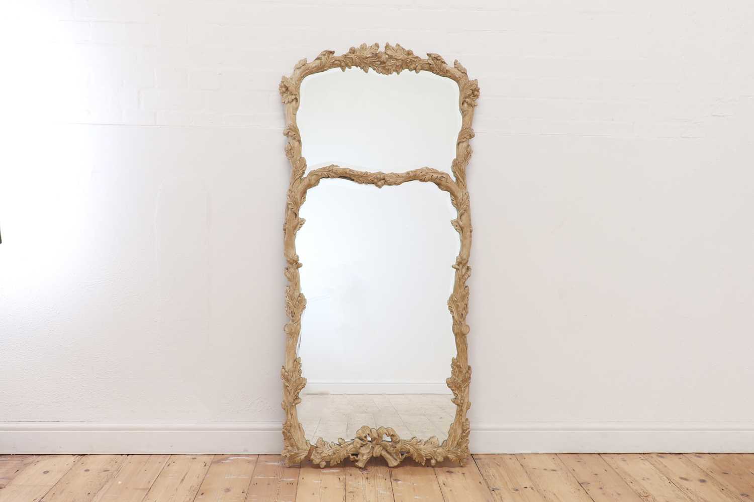 Lot 83 - A carved wooden mirror in the Black Forest style