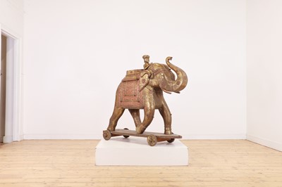 Lot 140 - A large copper and brass-clad pull-along elephant