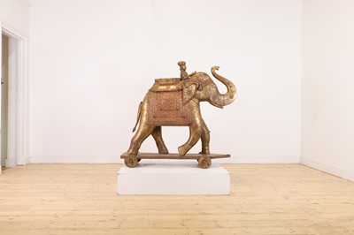 Lot 140 - A large copper and brass-clad pull-along elephant