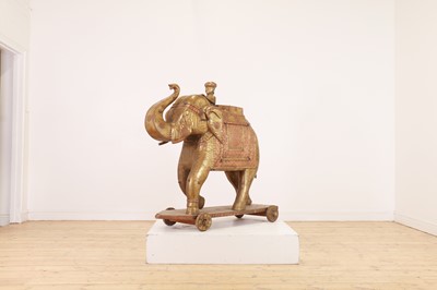 Lot 140 - A large copper and brass-clad pull-along elephant