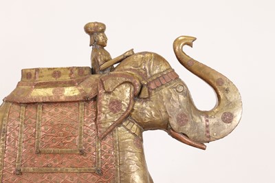 Lot 140 - A large copper and brass-clad pull-along elephant
