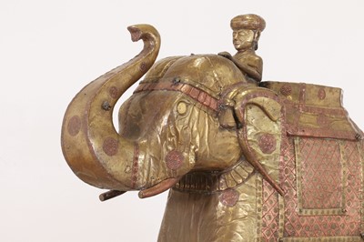 Lot 140 - A large copper and brass-clad pull-along elephant