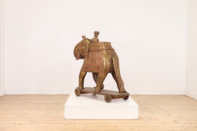 Lot 140 - A large copper and brass-clad pull-along elephant