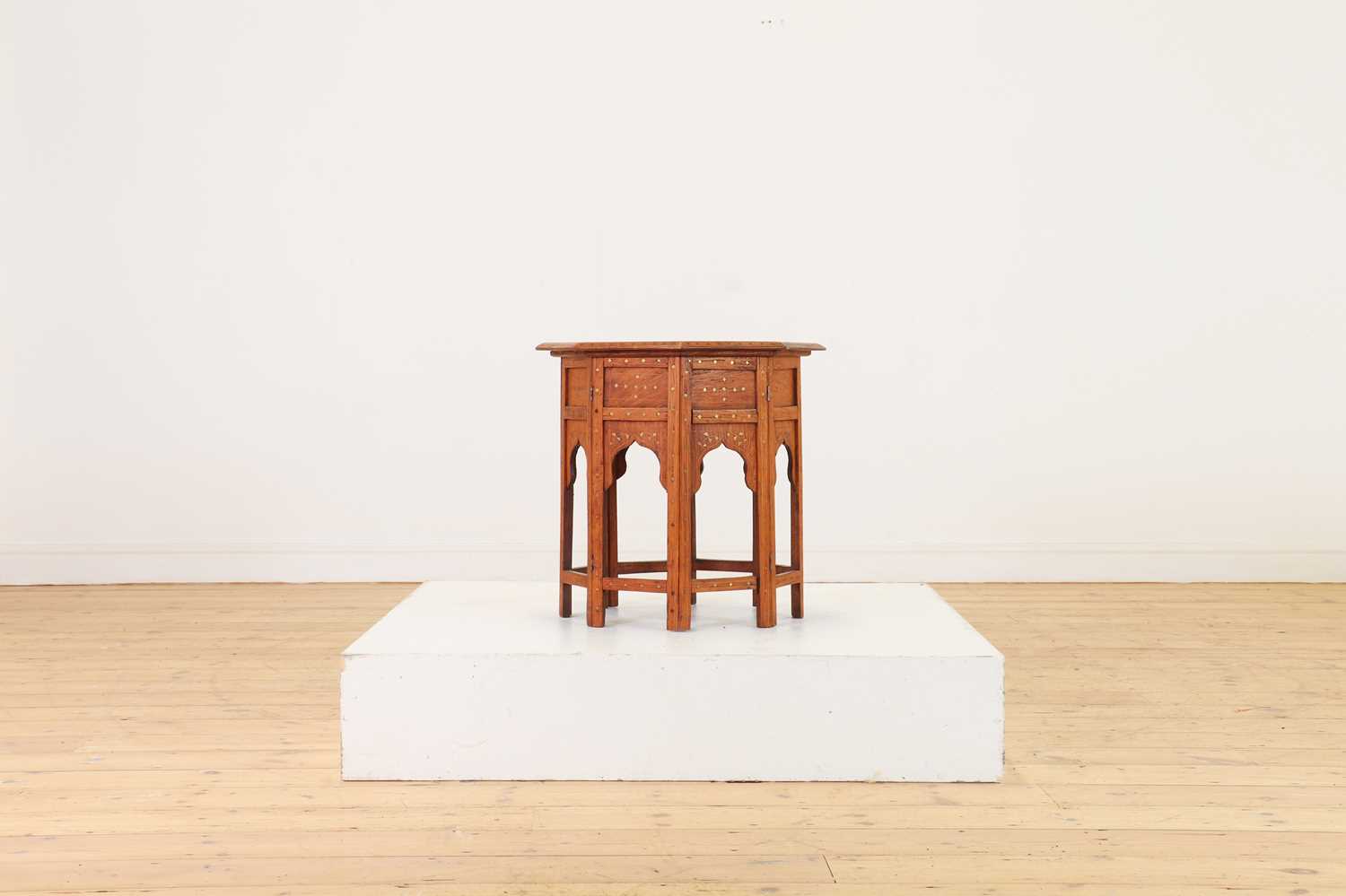 Lot 134 - A teak and brass octagonal occasional table