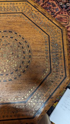 Lot 134 - A teak and brass octagonal occasional table