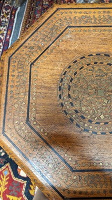 Lot 134 - A teak and brass octagonal occasional table