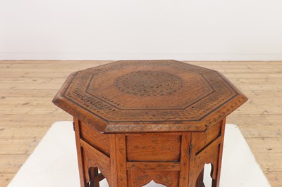 Lot 134 - A teak and brass octagonal occasional table