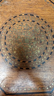 Lot 134 - A teak and brass octagonal occasional table