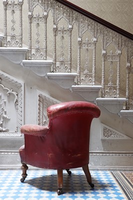 Lot 9 - A red-leather-upholstered tub armchair by Strahan & Co.