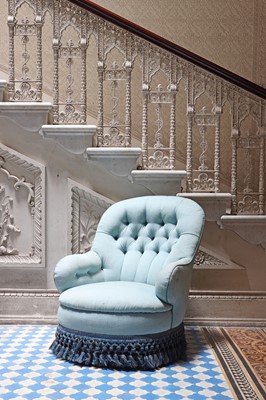 Lot 15 - A button-upholstered spoon-back armchair