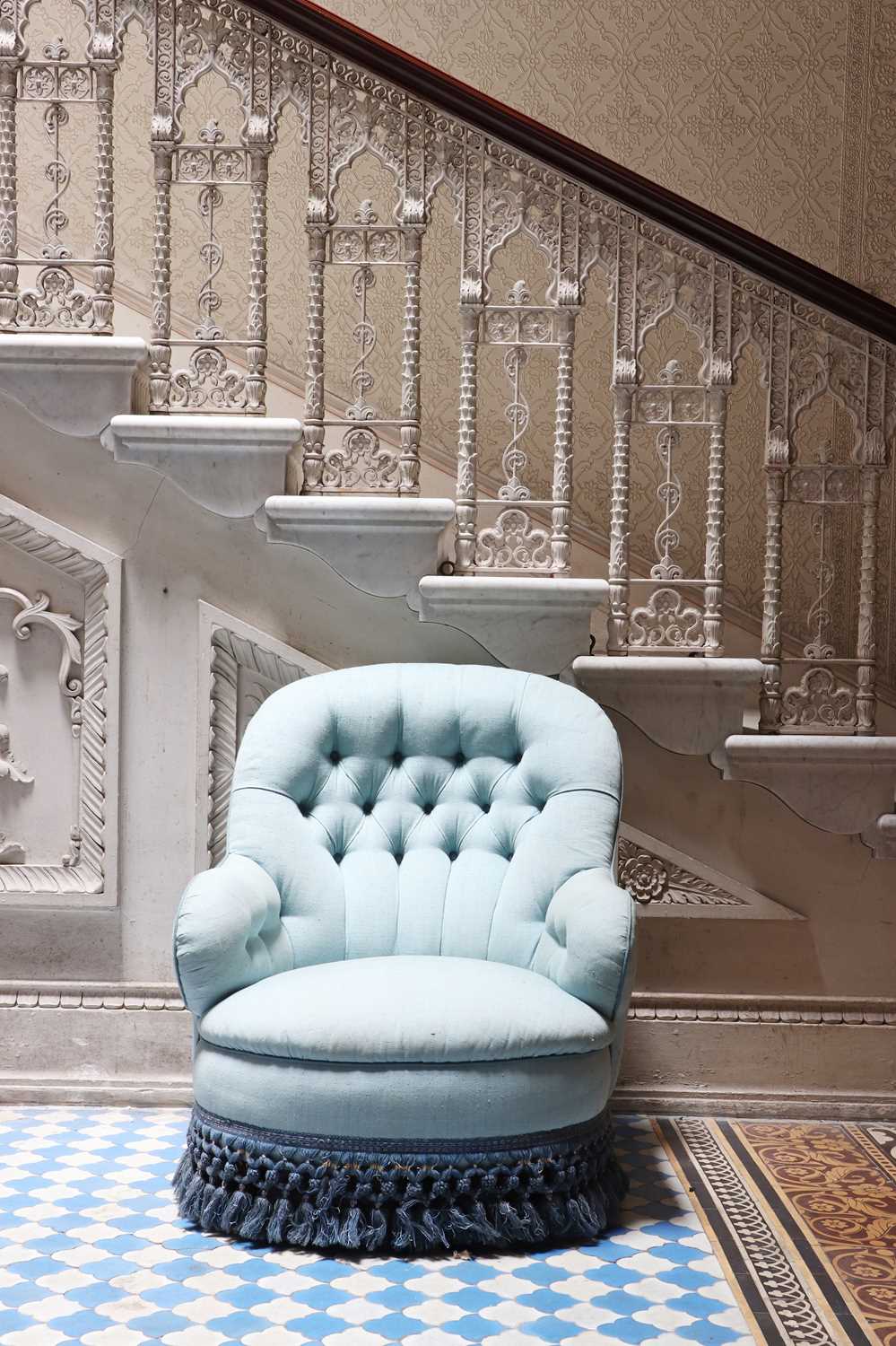 Lot 15 - A button-upholstered spoon-back armchair