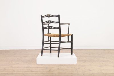 Lot 17 - An ebonised wooden elbow chair