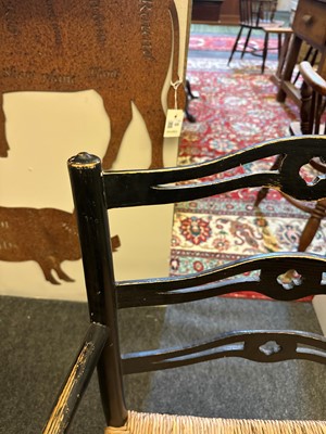 Lot 17 - An ebonised wooden elbow chair