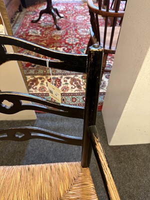 Lot 17 - An ebonised wooden elbow chair