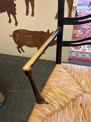 Lot 17 - An ebonised wooden elbow chair