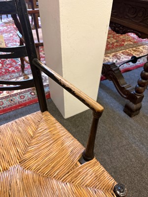 Lot 17 - An ebonised wooden elbow chair